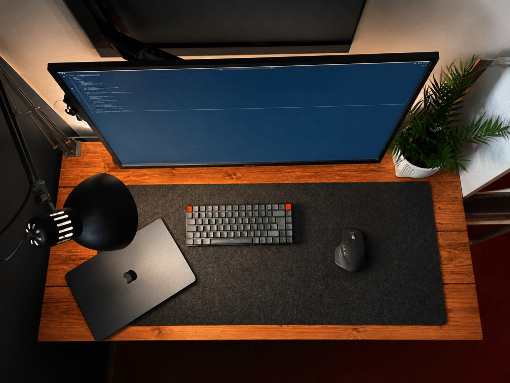 Image of a fairly modest looking desk setup with a few accessories from above.