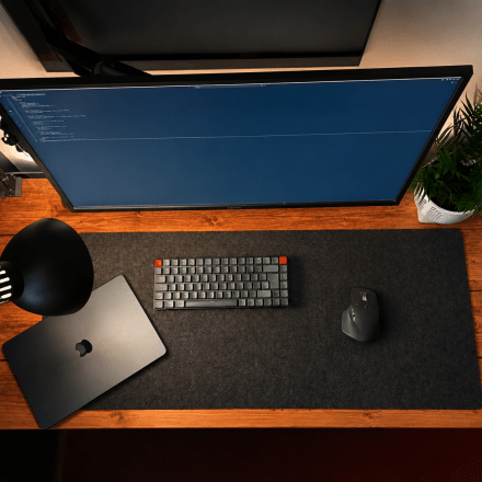 Image of a fairly modest looking desk setup with a few accessories from above.