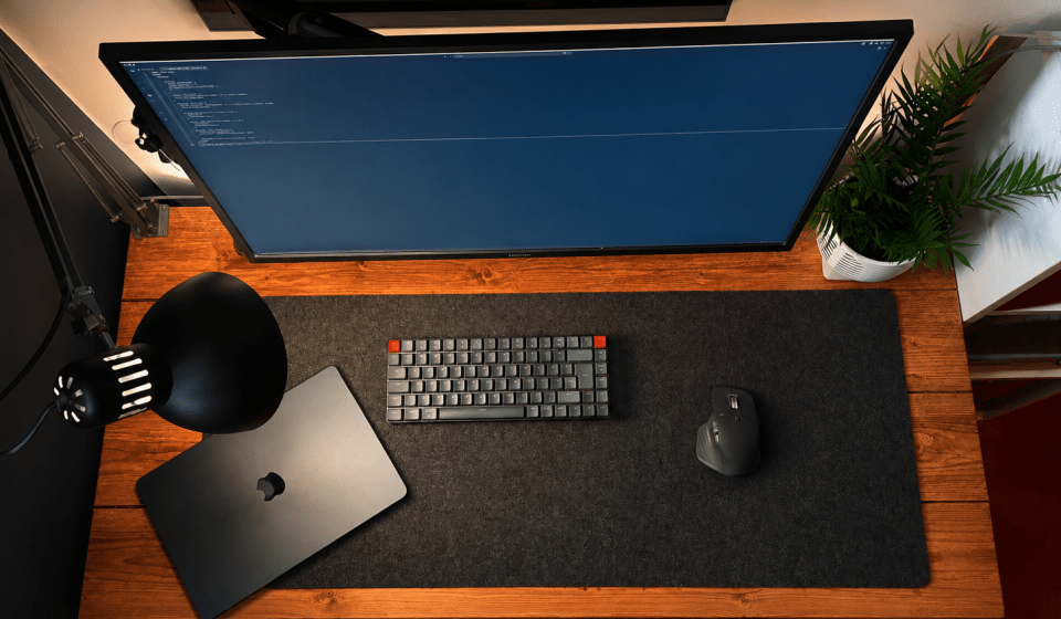 Image of a fairly modest looking desk setup with a few accessories from above.
